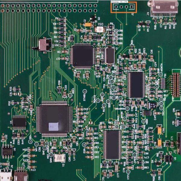 A close-up photo of a computer motherboard, showing its many integrated circuits.